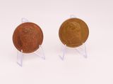 pair of two coins sitting on top of each other on a white surface
