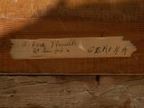 a piece of paper on a piece of wood with writing on it