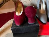 two pairs of shoes sitting on top of a box