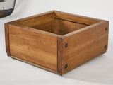 a wooden box that is sitting on a white surface