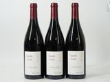 three bottles of wine sitting on top of a table next to each other