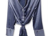 navy blue satin shirt with white pips and a tie around the collar