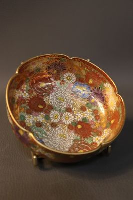 an image of a small bowl with flowers on it on a table