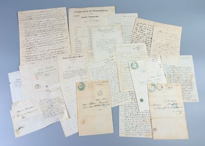 several old letters and papers are piled together on a blue surface