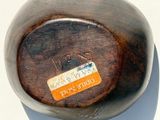 a wooden bowl that has a label on it