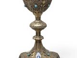 an image of a silver cup with blue stones on it