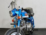 a blue motorcycle parked in a room with a white wall
