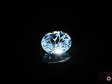 a close up of a blue diamond on a black surface
