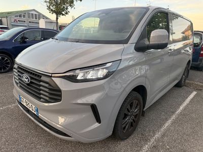 a silver van parked in a parking lot next to other cars