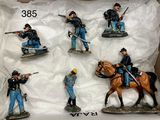 six figurines of soldiers on display in a box