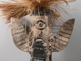 a sculpture of an elephant made out of wood and grass