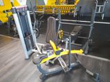 yellow and black gym equipment in a gym room with wooden flooring