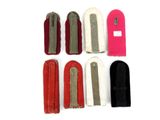 six pairs of red, white, and black hair clips on a white surface