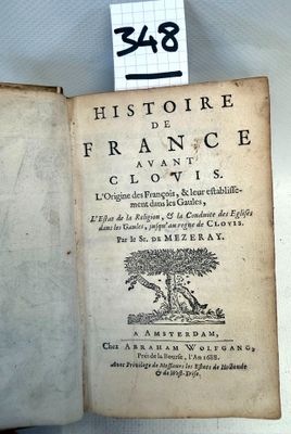 an old book with a sticker on it sitting on a table