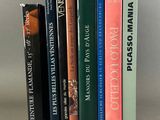 several books are stacked on top of each other on a table