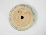 a white bowl with a brown lid on a table