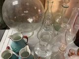 a table with a lot of glass and vases on it