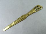 a gold scissors that is sitting on a table