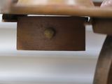 a close up of a wooden table with a drawer underneath it