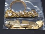 a gold bracelet and a gold bracelet on a black table
