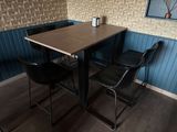 a table and two chairs in the corner of the room