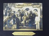 an old photo of a group of people standing in front of a building