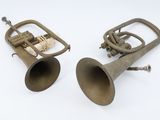 pair of antique brass musical instruments on a white background