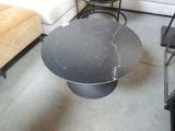 a black table with a marble top in a living room