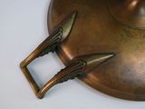 a brass plate with a pair of scissors on top of it