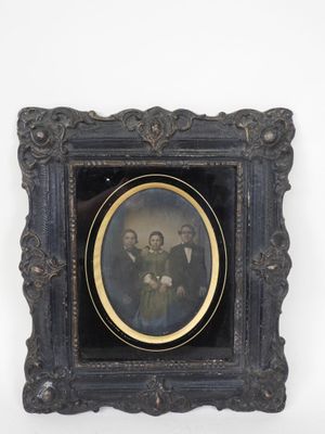 an old picture of a group of people in a black frame