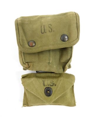 an old pair of military pouchs sitting on top of each other