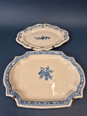 two blue and white plates with blue flowers on them on a blue surface
