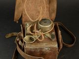 leather case with a pair of binoculars in it on a black background