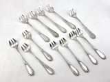 a lot of forks and spoons sitting on a table
