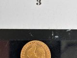 an image of a gold coin sitting on top of a black surface