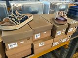 boxes of shoes are stacked on top of each other in a store