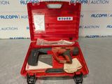 a red tool case with tools in it on a table