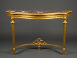 une table console en or avec un plateau en marbre