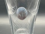 a glass cup with a ball in it sitting on a table