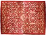 un tapis rouge orné de motifs dorés et blancs