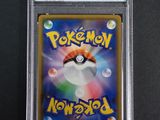 a close up of a pokemon card on a black surface