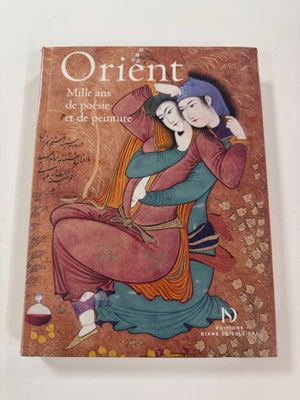 an old book with a picture of a woman sitting on the ground