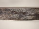 a close up of a knife on a white surface