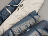 three bags that are laying on the floor