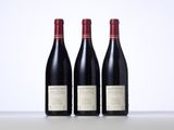 three bottles of wine sitting on top of a table next to each other