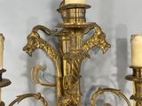 a gold colored candle holder with three candles on it