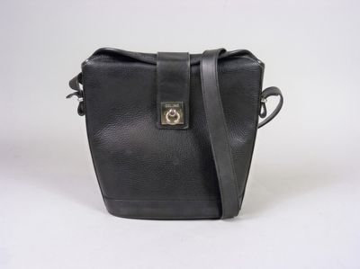 a black leather bag with a metal clasp on the front