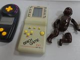 a toy of a baby and a cell phone next to it