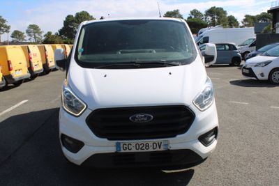 a white ford transit van parked in a parking lot