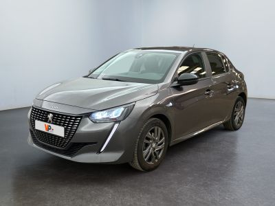 the grey car is parked in a white room with a black floor